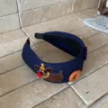 Cute navy blue ribbed knit headband featuring dog embroidery and decorative buttons - Navy Blue