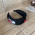 Cute black ribbed knit headband featuring an embroidered puppy patch and buttons. - Black