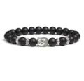 Close-up detail of black bead bracelet featuring silver Buddha head charm and metal spacers. - Black Bead