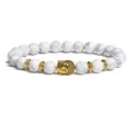 White stone beaded bracelet with golden Buddha head charm and metal spacers for daily wear. - White Textured Round Beads
