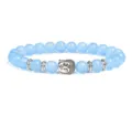 Detailed closeup of 8mm blue beaded bracelet featuring silver Buddha head charm and metal spacers. - Blue Semi-precious Stone