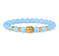 Blue gemstone bead bracelet with a central golden Buddha head charm and decorative spacers. - Blue Beaded