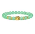 Green gemstone bead bracelet with gold Buddha head and metal spacers detail shot. - Green Amazonite