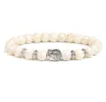 Detail shot of the white crackle stone beaded bracelet featuring a silver Buddha head charm. - Crackle Beads