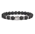 Close-up view of the black lava stone bracelet featuring a silver Buddha head charm. - Lava Stone