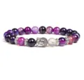 Close-up detail of purple agate beaded bracelet featuring silver Buddha head charm and metal spacers. - Purple Silk Agate