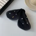 Elegant black tulle bow shark hair clip embellished with shimmering iridescent star charms - Black