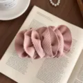 Elegant pink ruffled fabric banana clip for women shown in a chic lifestyle setting - 3D Flower Ruffle Style / Pink