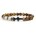 Detail shot of 8mm yellow tiger eye and chalcedony beaded bracelet featuring a black cross. - 11