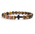 Detail view of the 8mm tiger eye stone beaded bracelet with black cross charm for daily wear. - 22