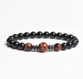 Close-up detail of the beaded bracelet showing polished black and red tiger eye beads. - Finished Bracelet Elastic approx 20cm / Carnelian