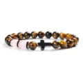 Detailed close-up of yellow tiger eye stone and pink chalcedony beaded bracelet with black cross. - Style 3