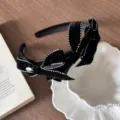 Vintage style black velvet headband featuring bows with white dotted stitching details - Headband
