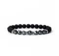 Detailed shot of the black matte beaded bracelet with faceted metallic center stones. - 6