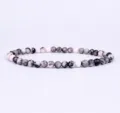 Detailed shot of 4mm natural stone beaded bracelet highlighting smooth round bead textures. - Black White Gray Pink
