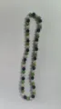Close-up detail of 10mm AB clay rhinestone disco ball beads on a Shamballa necklace. - Grass Green Black AB White