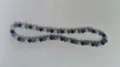 Close-up view of 10mm rhinestone Shamballa beads in blue, black and silver AB tones - Blue Black Silver White