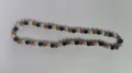 Detailed view of 10mm Shamballa disco ball necklace with black, amber, and white rhinestones - Black Gold AB White