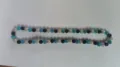 Detail view of a 10mm turquoise and black Shamballa disco ball bead hip hop necklace - Bright Blue Black AB White