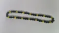 Close-up of 10mm black and yellow sparkling Shamballa disco ball bead necklace detail. - Black and Yellow