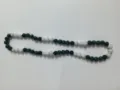 Close-up detail of 10mm dark green and AB white rhinestone disco ball bead necklace - Green Black AB White