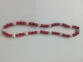 Close-up view of red and white 10mm polymer clay drill ball beads on a Shamballa necklace. - 83 / Approx. 44 Beads, Approx. 51cm (20 Inches)
