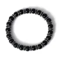 Nahaufnahme des eleganten schwarzen Perlenarmbands mit funkelnden Strass-Abstandsringen im Detail. - Schwarz