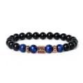 Close-up detail of blue tiger eye stone and black beads bracelet with rose gold cubic spacer. - Style 32