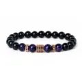 Detailed view of the 8mm tiger eye and black stone beaded bracelet with zirconia charms. - Style 28