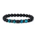 Close-up detail of beaded bracelet featuring blue tiger eye, black beads and sparkling spacers. - Style 21