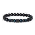 Detailed shot of beaded bracelet featuring blue tiger eye, black stones and pavé zirconia spacers. - Style 18