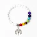 Close-up detail of the 7 chakra beads and silver tree of life charm on the yoga bracelet. - 23