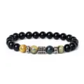 Detailed view of the 8mm tiger eye and black onyx beaded bracelet with cubic zirconia charm. - Style 7