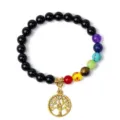 Close-up detail of the 8mm chakra beaded yoga bracelet featuring a golden tree of life pendant charm. - 36