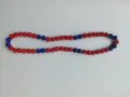 Detailed view of 10mm red and blue clay pavé disco ball beads on a Shamballa necklace - 119 / Approx. 44 Beads, Approx. 51cm (20 Inches)