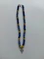 Close-up detail of blue and gold rhinestone pave bead necklace featuring a sparkling cross pendant. - Cross Pendant Style / Color Matched Bracelet (Approx 19cm, ~20 Beads, Elastic Line, No Clasp) / Blue-Yellow