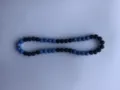 Detailed view of blue and black clay pave disco beads on a Shamballa style necklace - Blue/Black