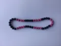 Detail shot of Shamballa clay rhinestone beads on a pink and black elastic necklace - Pink & Black