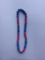 Close-up view of a vibrant blue and pink rhinestone Shamballa bead necklace set. - Blue & Pink
