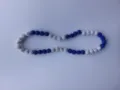 Close-up detail of shamballa necklace featuring blue and white sparkling rhinestone beads - Blue & White