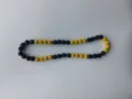 Detailed macro view of black and yellow sparkling Shamballa disco ball bead necklace - Yellow & Black