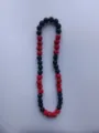 Close-up detail of 12mm red and black Shambhala pavé crystal beads on this elastic necklace - Red and Black