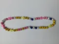 Detailed view of colorful rhinestone disco ball beads and cross spacers on elastic necklace - Multi-color with Cross