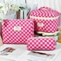 Detailed view of pink checkerboard quilted cosmetic bag set shown in three sizes - L / Pink Checkerboard