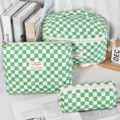 Detail view of the three-piece quilted cosmetic bag set in green checkered pattern. - Green Checkerboard