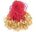 Detail shot of golden lobster clasps with pink phone lanyards for DIY accessories crafting. - Pink