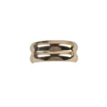 Macro view of a gold-colored C-shape ribbed fashion brooch with a high polished finish - Gold