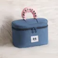 Detailed view of the blue denim cosmetic bag with a cute pink numbered handle. - Denim Blue Large