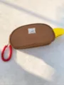 Detailed view of the color-blocked brown cosmetic bag with a red coiled wrist strap - Brown Small