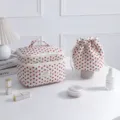 Quilted strawberry print cosmetic bag set with drawstring pouch on vanity - Strawberry